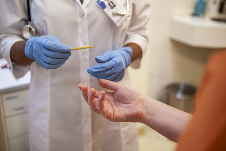 A patient's hand reaching out to a nurse