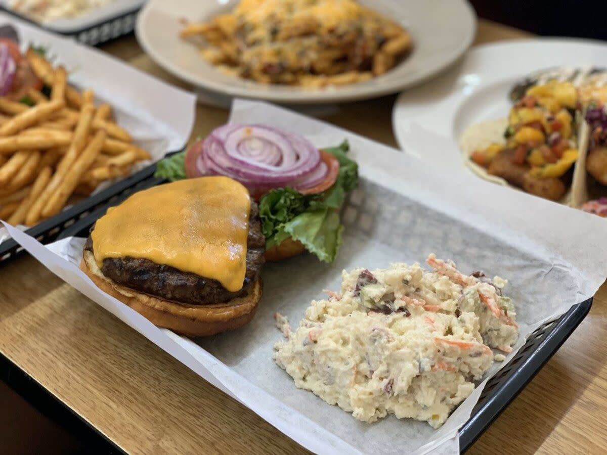 Cheese Burger with Potato Salad at Whoa Nellie Deli, Lee Vining, California, surrounded by other entrees