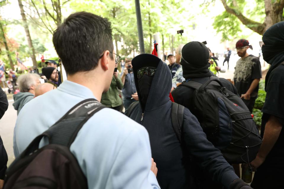 Brian Fife, a prominent far-right figure, is confronted by Black Bloc protesters on Sunday in Portland, Oregon. (Photo: John Rudoff for HuffPost)