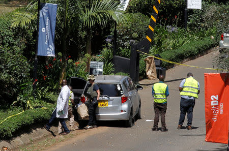 Kenyan policemen and explosives experts gather evidence from the car suspected to have been used by the attackers outside the scene where explosions and gunshots were heard at The DusitD2 complex, in Nairobi, Kenya January 17, 2019. REUTERS/Njeri Mwangi