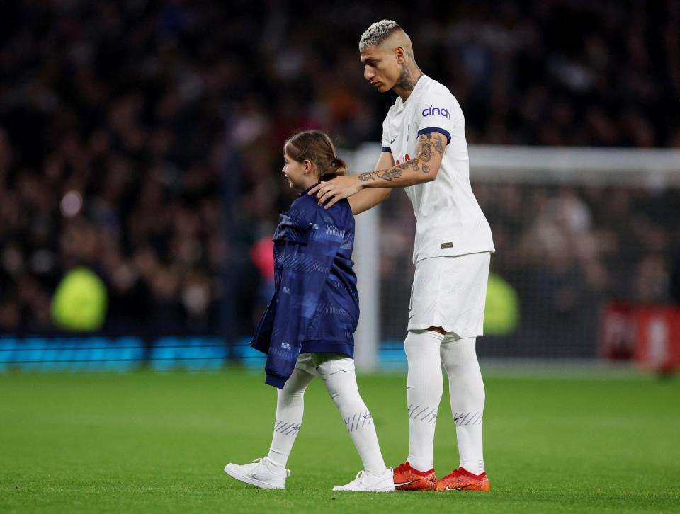 Tottenham Hotspur's Richarlison with a mascot