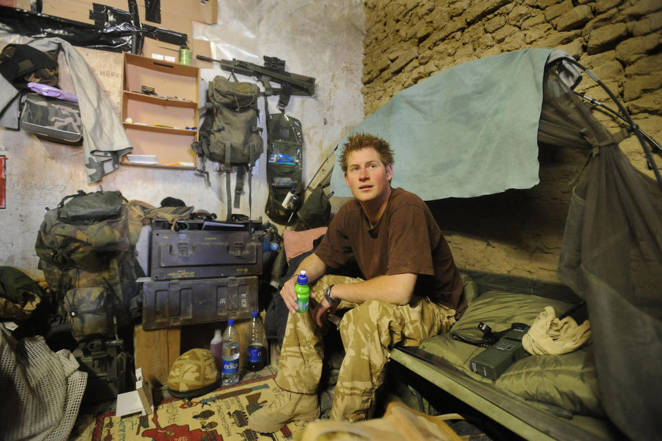 Britain's Prince Harry sits on his camp bed on January 02, 2008, in his accommodation at FOB Delhi (forward operating base), in Helmand province in Southern Afghanistan. Prince Harry, the youngest son of Prince Charles and the late princess Diana, has been fighting the Taliban on the front line in Afghanistan, the defence ministry in London said Thursday. The 23-year-old, an officer in the Household Cavalry regiment, has spent the past 10 weeks secretly serving in the volatile southern province of Helmand, where most of Britain's troops are based. AFP PHOTO/John Stillwell/PA POOL (Photo by JOHN STILLWELL / POOL / AFP) (Photo by JOHN STILLWELL/POOL/AFP via Getty Images)