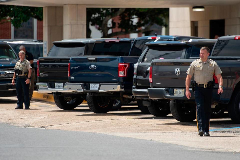 Jackson County Sheriff John Ledbetter, right, walks outside of the Jackson County Courthouse on Thursday, July 18, 2024, as a protest is held in the parking lot in support of Heather Wyatt.