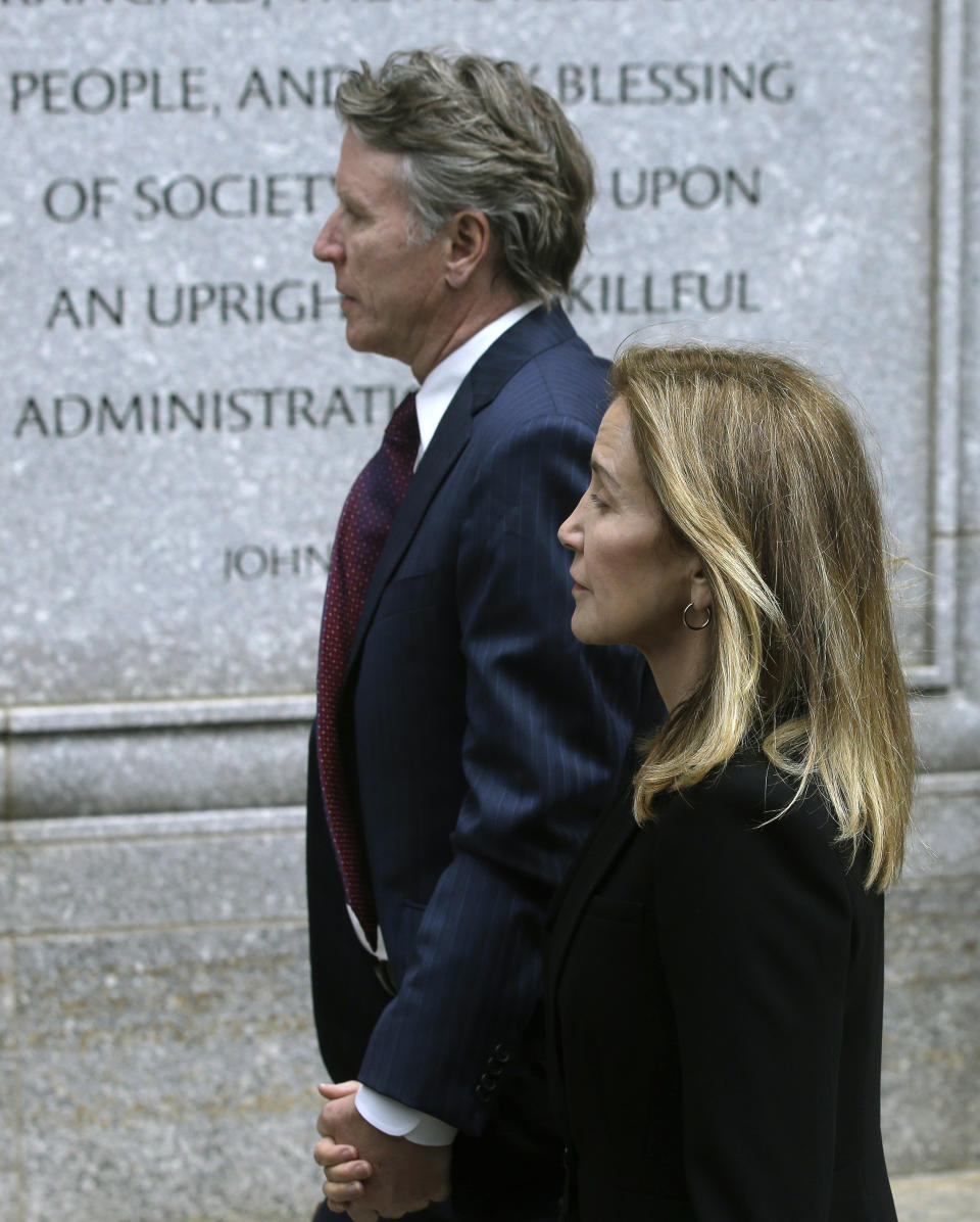 Actress Felicity Huffman arrives with her brother Moore Huffman Jr., at federal court Monday, May 13, 2019, in Boston, where she is scheduled to plead guilty to charges in a nationwide college admissions bribery scandal. (AP Photo/Steven Senne)