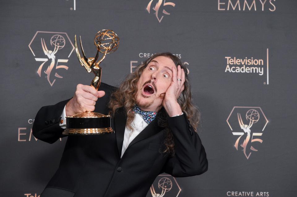 "Weird Al" Yankovic poses in the press room with the award for outstanding television movie during night one of the Creative Arts Emmy Awards on Saturday.
