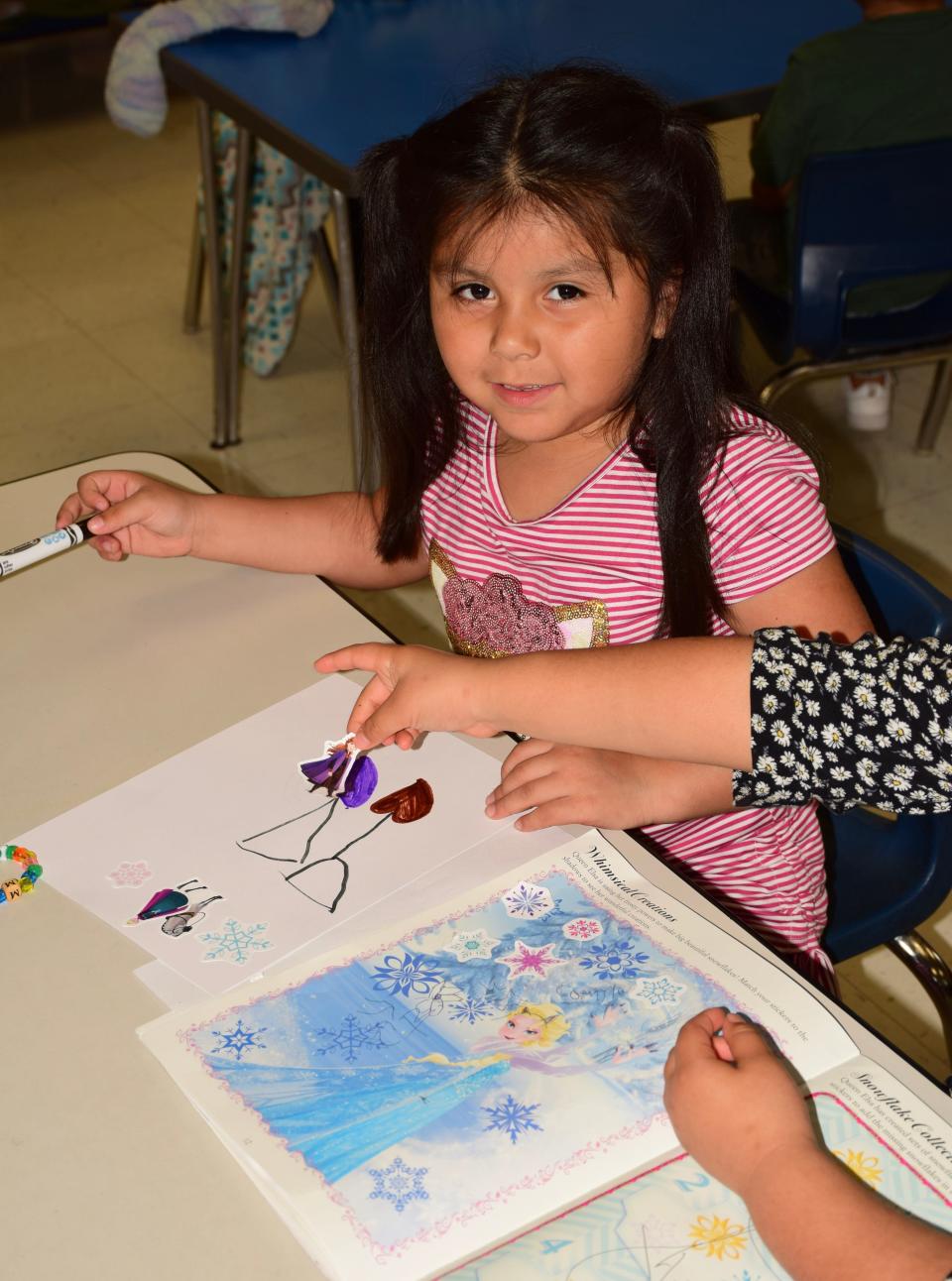 Mia, a student at Inter-Faith Community Preschool in Fort Smith, draws pictures on a recent weekday. The preschool that opened in 1967 will close May 17.