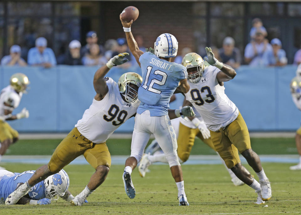 Notre Dame’s Jerry Tillery (L) and Jay Hayes (R) rush North Carolina quarterback Chazz Surratt (C) during the second half of an NCAA college football game in Chapel Hill, N.C., Saturday, Oct. 7, 2017. Notre Dame won 33-10. (AP)