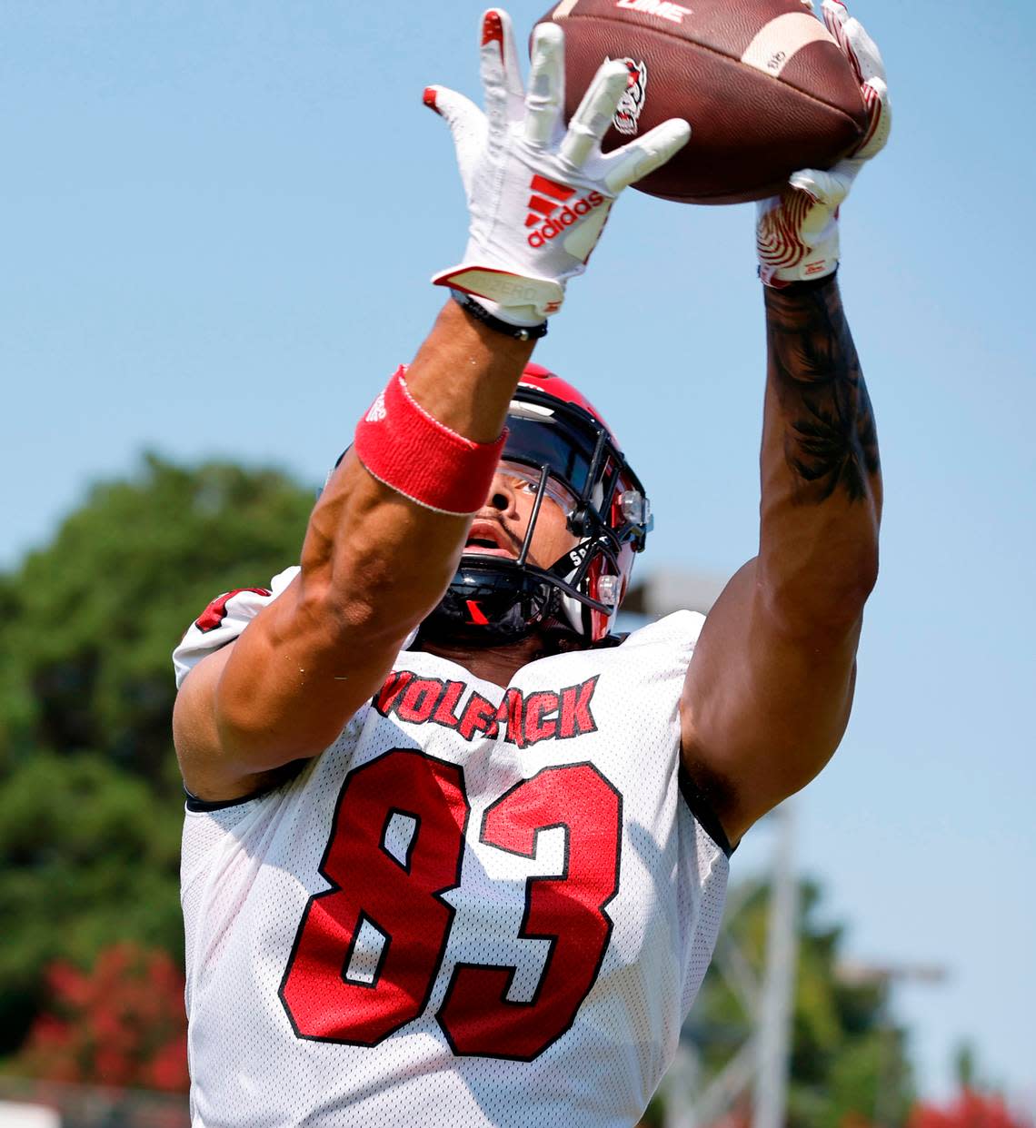 N.C. State wide receiver Josh Crabtree (83) keeps his eyes on the ball as he pulls in a pass during the Wolfpack’s first practice of fall camp in Raleigh, N.C., Wednesday, August 3, 2022.