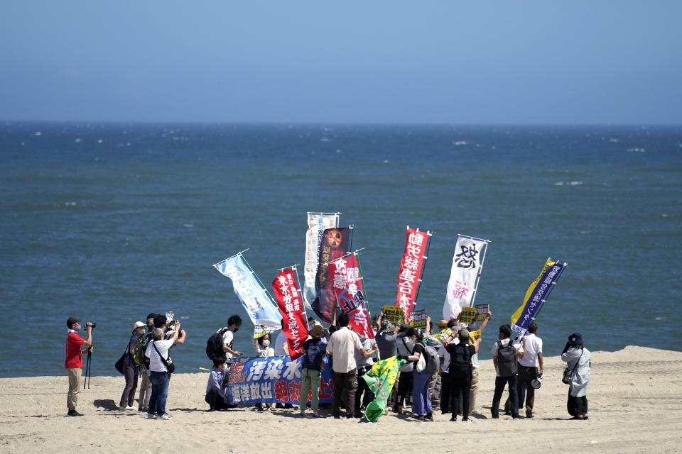 People protest at a beach toward the Fukushima Daiichi nuclear power plant, damaged by a massive March 11, 2011 earthquake and tsunami, in Namie town, northeastern Japan, on Aug. 24, 2023. Fishing communities in Fukushima feared devastating damage to their businesses from the tsunami-wrecked nuclear power plant’s ongoing discharge of treated radioactive wastewater into the sea. Instead, they're seeing increased consumer support as people eat more fish, a movement in part helped by China’s ban on Japanese seafood. (AP Photo/Eugene Hoshiko)