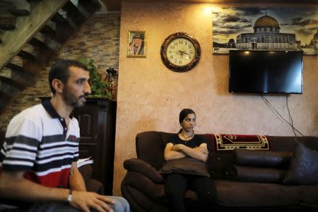 Palestinian Tamara Abu-Laban, 16, sits on a couch near her father, Moammar, during her interview with Reuters at her house in East Jerusalem October 8, 2017. Picture taken October 8, 2017. REUTERS/Ammar Awad