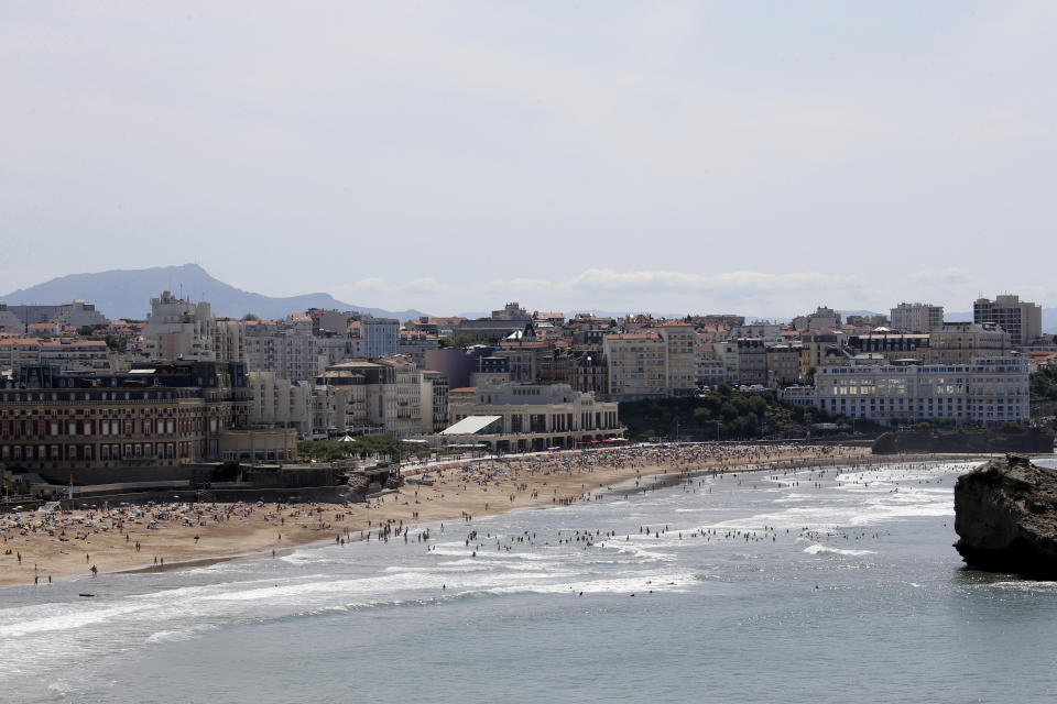 The beach of Biarritz, with G7 summit venues the Hotel du Palais, left, the Casino Municipal, center, and the Casino Bellevue, right, Wednesday, Aug. 21, 2019 in Biarritz, southwestern France. Leaders of the Group of Seven nations will meet Saturday for three days in the southwestern French resort town of Biarritz. France holds the 2019 presidency of the G-7, which besides the U.S. also includes Britain, Canada, Germany, Italy and Japan. (AP Photo/Bob Edme)