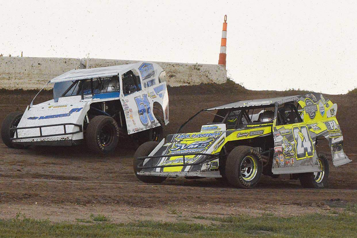 Mike Stearns of Aberdeen (24S) and Tim Thomas of West Fargo, N.D. (51T) run side-by-side during a modified heat race on Sunday, Aug. 11, 2024 at Casino Speedway in Watertown.