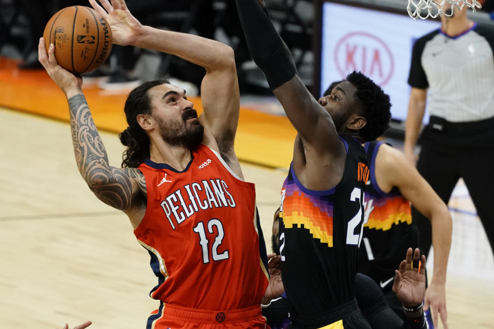 New Orleans Pelicans center Steven Adams (12) shoots over Phoenix Suns center Deandre Ayton during the first half of an NBA basketball game, Tuesday, Dec. 29, 2020, in Phoenix. (AP Photo/Rick Scuteri)