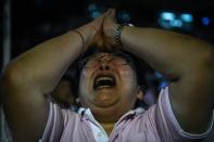 A woman reacts to the death of Thailand's King Bhumibol Adulyadej in Bangkok on October 13, 2016