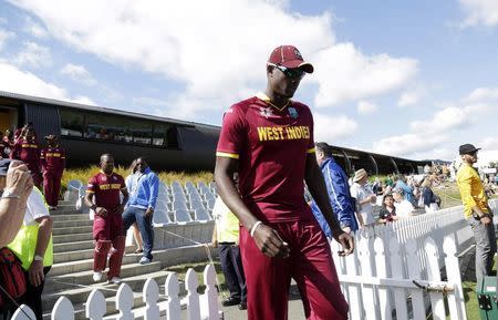 West Indies captain Jason Holder leads his team out for their Cricket World Cup match against Ireland in Nelson February 16, 2015. REUTERS/Anthony Phelps