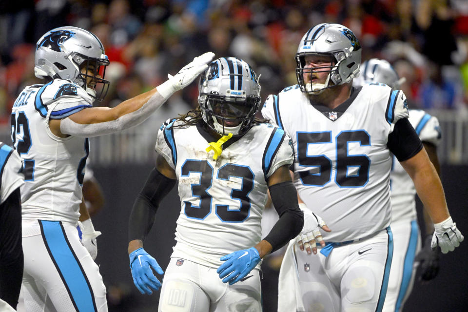 Carolina Panthers running back D'Onta Foreman (33) is congratulated by Tommy Tremble, left, and Bradley Bozeman (56) after scoring during the first half of an NFL football game against the Atlanta Falcons Sunday, Oct. 30, 2022, in Atlanta. (AP Photo/John Amis)