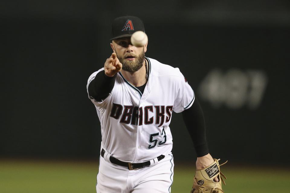 Arizona Diamondbacks first baseman Christian Walker tosses the ball to Diamondbacks pitcher Matt Andriese to get San Diego Padres' Eric Hosmer out at first base during the fourth inning of a baseball game Friday, Sept. 27, 2019, in Phoenix. (AP Photo/Ross D. Franklin)