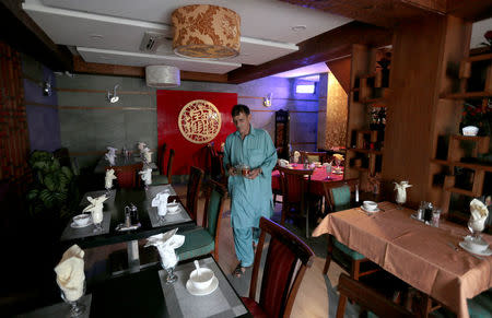 A waiter prepares tables at a Chinese restaurant catering to the growing Chinese population in Islamabad, Pakistan June 10, 2017. REUTERS/Caren Firouz