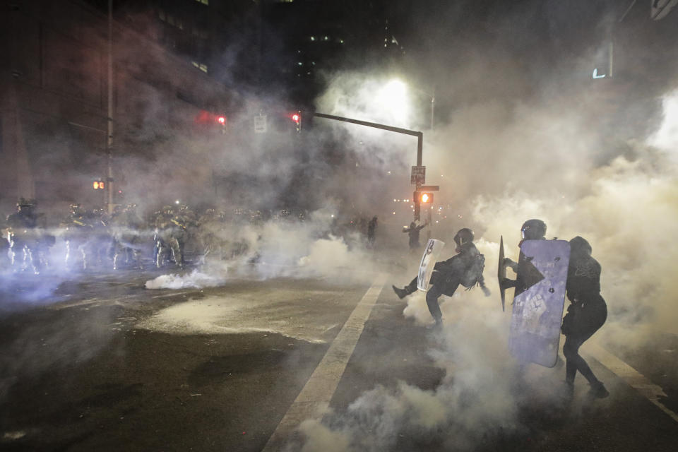 Demonstrators back away from federal officers during a Black Lives Matter protest at the Mark O. Hatfield United States Courthouse Friday, July 24, 2020, in Portland, Ore. (AP Photo/Marcio Jose Sanchez)