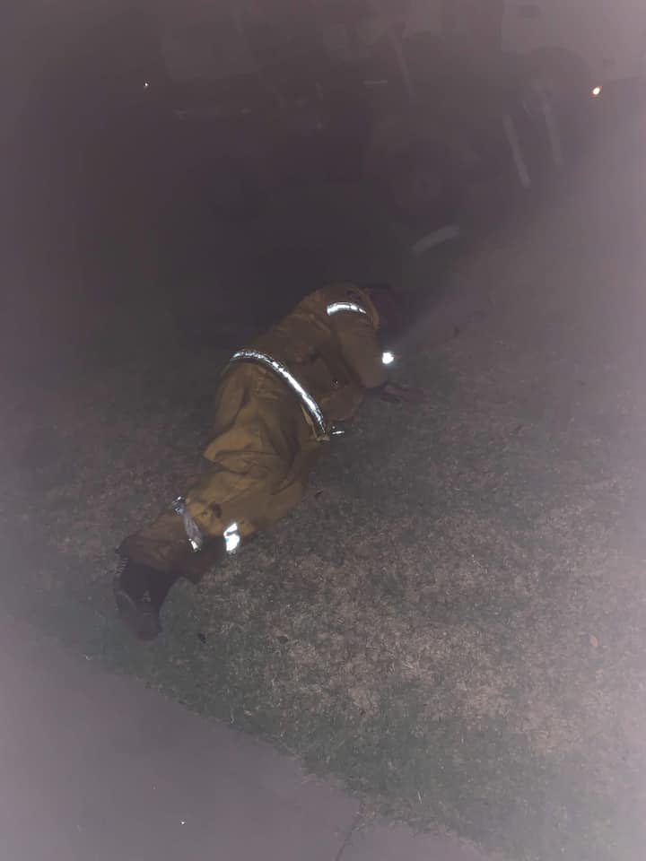 A Facebook photo a NSW woman shared showing her exhausted volunteer firefighter dad lying on their front lawn.