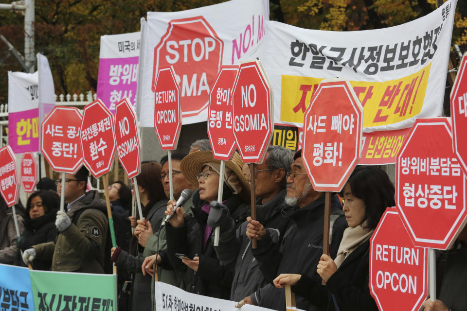 Protesters stage a rally to oppose a visit by U.S. Secretary for Defense Mark Esper in front of the Defense Ministry in Seoul, South Korea, Friday, Nov. 15, 2019. The sign reads "We demand to abolish the General Security of Military Information Agreement, or GSOMIA, an intelligence-sharing agreement between South Korea and Japan." (AP Photo/Ahn Young-joon)