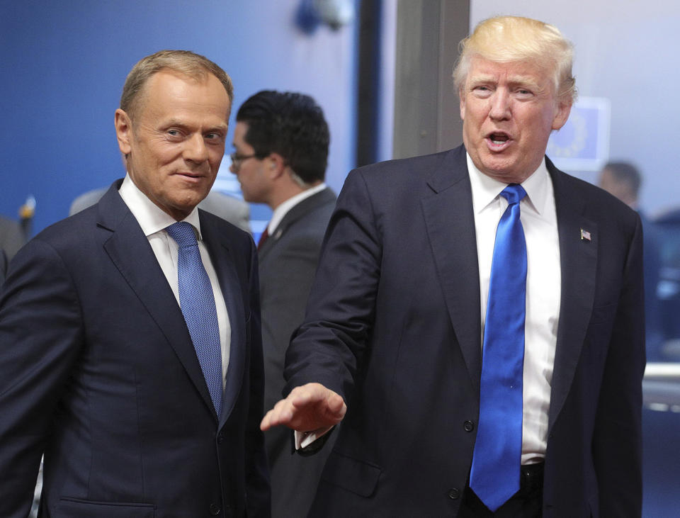 FILE - U.S. President Donald Trump is greeted by European Council President Donald Tusk as he arrives at the Europa building in Brussels on Thursday, May 25, 2017. As Trump becomes the first former president to face federal charges that could put him in jail, many Europeans are watching the case closely. But hardly a single world leader has said a word recently about the man leading the race for the Republican party nomination. (AP Photo/Olivier Matthys, File)