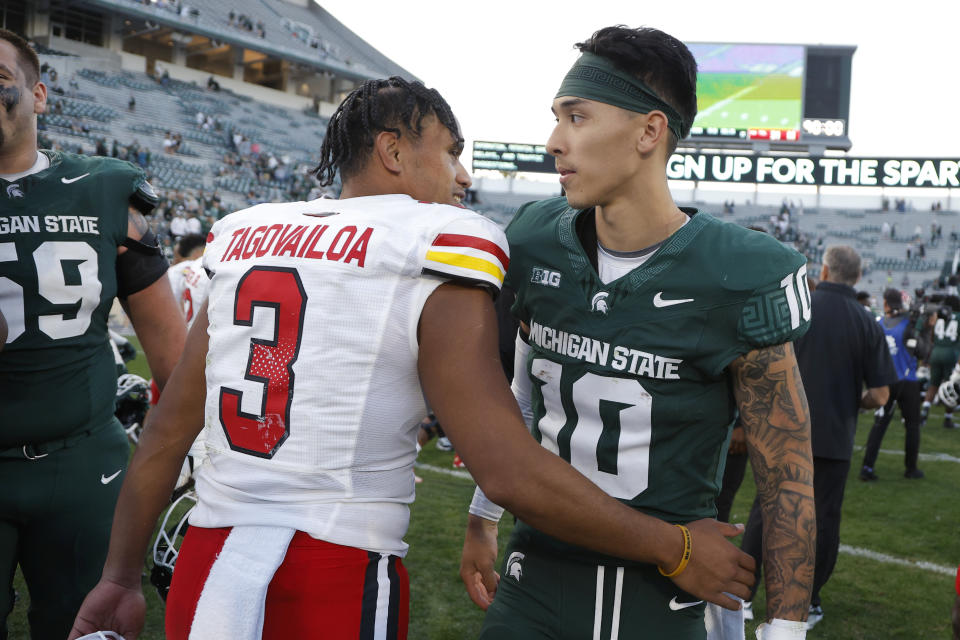 Maryland quarterback Taulia Tagovailoa, left, and Michigan State quarterback Noah Kim, right, greet each other following an NCAA college football game, Saturday, Sept. 23, 2023, in East Lansing, Mich. (AP Photo/Al Goldis)