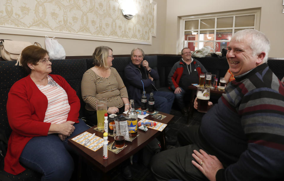 People talk at the Hartlepool Working Men's club in Hartlepool, England, Sunday, Nov. 10, 2019. Britain's political parties are battling to win Hartlepool and places like it: working-class former industrial towns whose voters could hold the key to 10 Downing Street, the prime minister's office. Hartlepool has elected lawmakers from the left-of-center Labour Party for more than half a century. But in 2016, almost 70% of voters here backed leaving the European Union. (AP Photo/Frank Augstein)