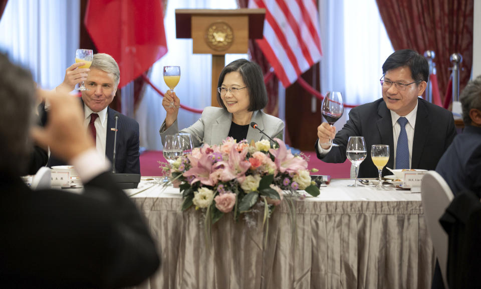 In this photo released by the Taiwan Presidential Office, House Foreign Affairs Committee Chairman Michael McCaul, R-Texas, left, and Taiwan's President Tsai Ing-wen, center, toast at a luncheon during a visit by a Congressional delegation to Taiwan in Taipei, Taiwan, Saturday, April 8, 2023. China sent warships and dozens of fighter jets toward Taiwan on Saturday, the Taiwanese government said, in retaliation for a meeting between the U.S. House of Representatives speaker and the president of the self-ruled island democracy claimed by Beijing as part of its territory.(Taiwan Presidential Office via AP)