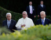 <p>Pope Francis is flanked by Israel’s President Shimon Peres, right, and Palestinian President Mahmoud Abbas during an evening of peace prayers in the Vatican gardens, Sunday, June 8, 2014. (AP Photo/Gregorio Borgia) </p>