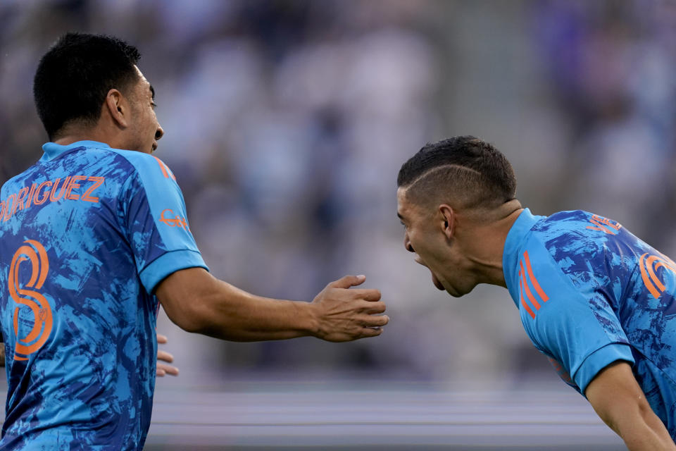 Houston Dynamo midfielder Matias Vera, right, celebrates with Homidfielder Memo Rodriguez (8) after scoring a goal during the first half of an MLS soccer match against Sporting Kansas City Saturday, May 29, 2021, in Kansas City, Kan. (AP Photo/Charlie Riedel)