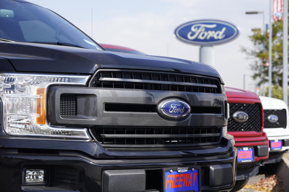 A row of 2020 F-150 pickup trucks sits at a Ford dealership Sunday, Oct. 11, 2020, in Denver. (AP Photo/David Zalubowski)