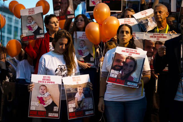 <p>Ilia Yefimovich/picture alliance via Getty</p> Protesters and relatives of the Israelis Bibas Family hold balloons and poster during a gathering calling for the family immediate release from Hamas militants on 28 November 2023 in Israel, Tel Aviv