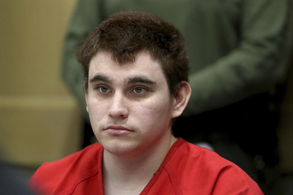 FILE - In this Aug. 15, 2018 file photo, Florida school shooting suspect Nikolas Cruz listens during a status check on his case at the Broward County Courthouse in Fort Lauderdale, Fla. Authorities say Cruz attacked a detention officer at the county jail, Tuesday, Nov. 13, and now faces new charges. Cruz is charged with killing 17 people and wounding 17 others in the Feb. 14 mass shooting at Marjory Stoneman Douglas High School. (Amy Beth Bennett/South Florida Sun-Sentinel via AP, Pool, File)