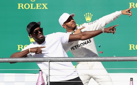 AUSTIN, TX - OCTOBER 22: Race winner Lewis Hamilton of Great Britain and Mercedes GP celebrates on the podium with sprinting legend Usain Bolt during the United States Formula One Grand Prix at Circuit of The Americas on October 22, 2017 in Austin, Texas - Credit: getty images