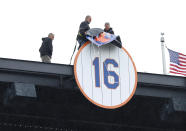 Workers reveal a No. 16 during former New York Mets player Dwight Gooden's number retirement ceremony at Citi Field before a baseball game between the Mets and the Kansas City Royals, Sunday, April 14, 2024, in New York. (AP Photo/Noah K. Murray)