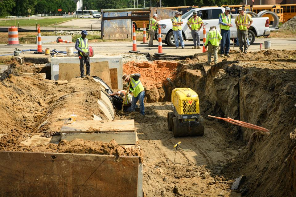 Construction crew works on repairing a large sinkhole on Raeford Road at 71st School Road and Graham Road on Tuesday, June 27, 2023. 