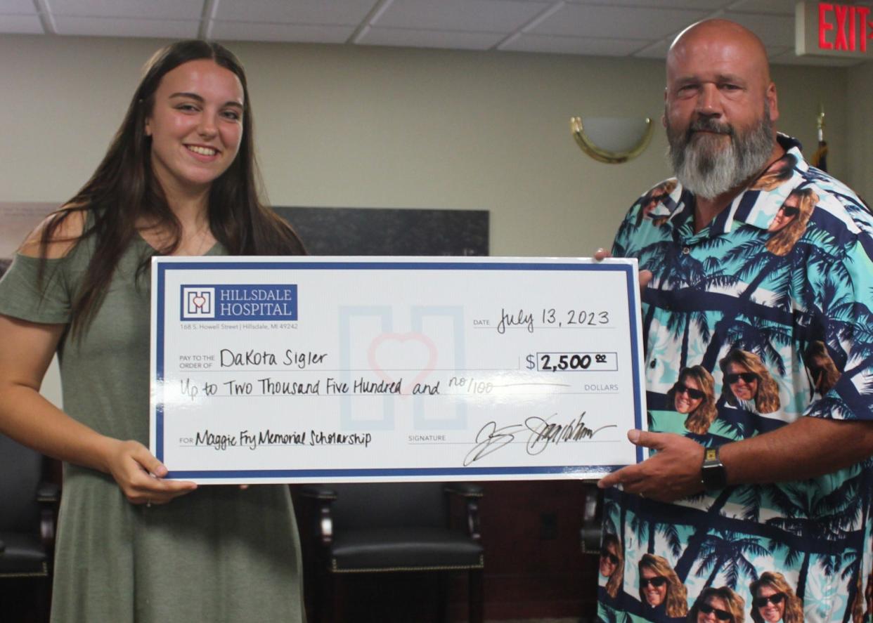 Maggie Fry’s husband, James ‘Jef’ Fry, is pictured with Dakota Sigler, first-time recipient of the Maggie Fry Memorial Scholarship for nursing education, at a private ceremony on July 14.