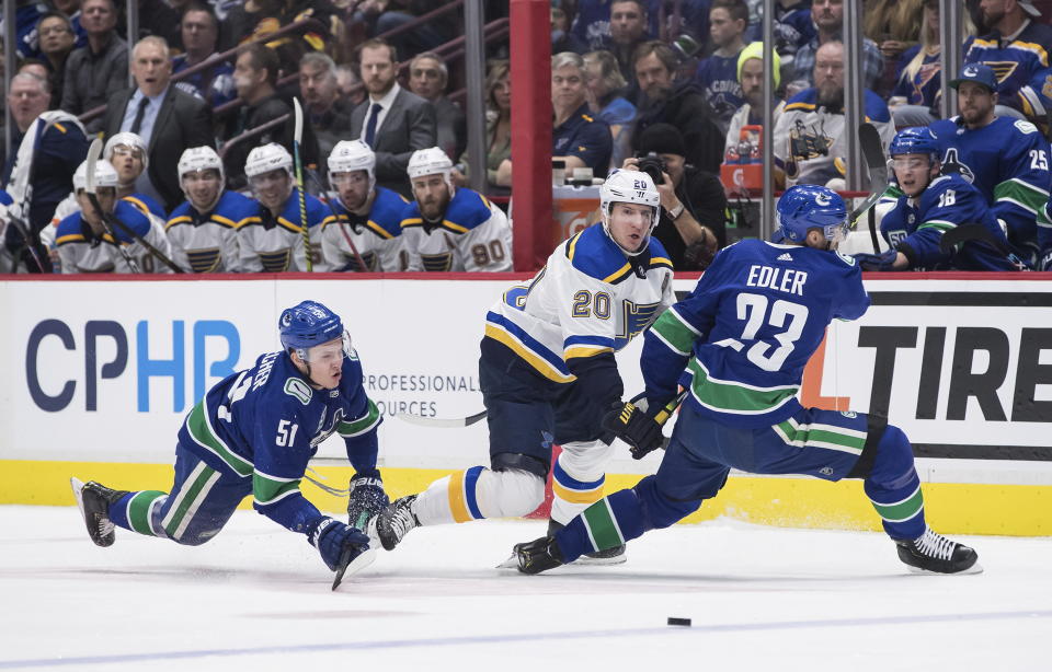 St. Louis Blues' Alexander Steen (20) collides with Vancouver Canucks' Troy Stecher (51) and Alexander Edler (23), of Sweden, during the first period of an NHL hockey game in Vancouver, British Columbia on Monday Jan. 27, 2020. (Darryl Dyck/The Canadian Press via AP)