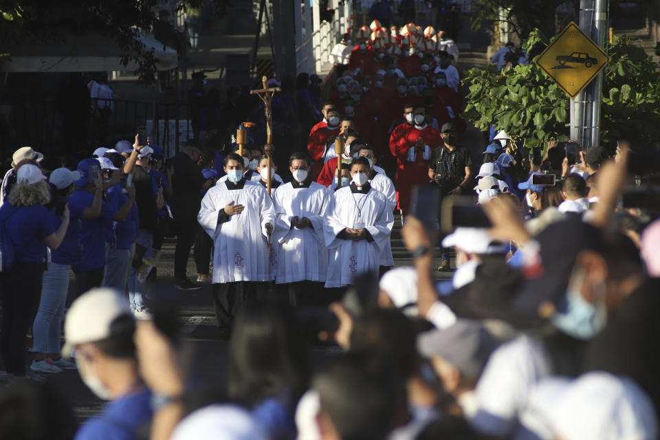 Altar servers lead a procession during a ceremony to beatify two priests, including Rev. Rutilio Grande and two lay people, all victims of right-wing death squads during El Salvador’s civil war, in San Salvador, Saturday, Jan. 22, 2022. The Rev. Rutilio Grande, a Jesuit priest killed alongside friends Manuel Solorzano and teenager Nelson Lemus on March 12, 1977, was known for his ministry to the poor and was an inspiration to St. Oscar Romero, the then-archbishop of El Salvador who himself was murdered three years later. (AP Photo/Salvador Melendez)