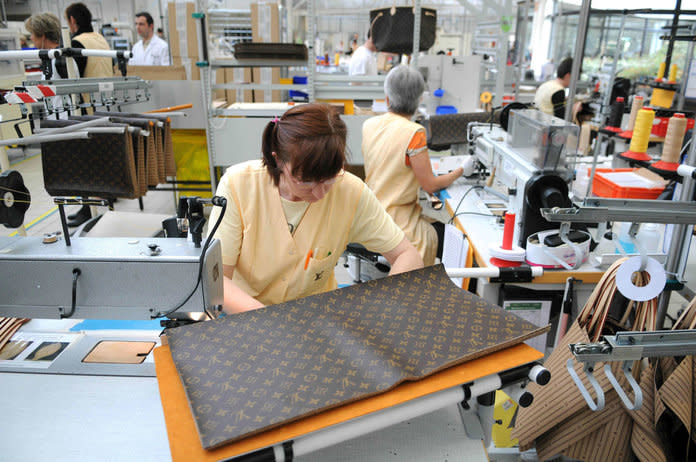 Employees at work in the 20,000-square-metre Louis Vuitton plant in Sioule, France. | Sipa/Shutterstock