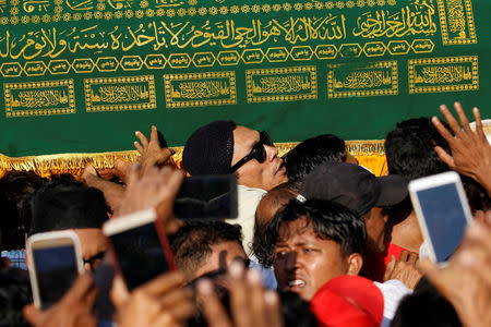 Supporters carry the coffin of Ko Ni, a prominent member of Myanmar's Muslim minority and legal adviser for Myanmar's ruling National League for Democracy, after he was shot dead, in Yangon, Myanmar January 30, 2017. REUTERS/Soe Zeya Tun/Files