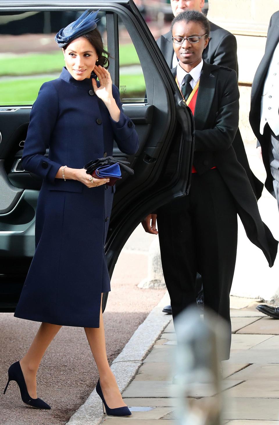 Markle returned to Windsor Castle for Princess Eugenie's October wedding in a modest Givenchy coatdress. The boxy silhouette caused some speculation about whether the Duchess was expecting.