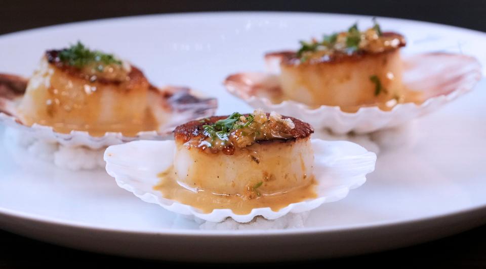 From the "More to Share" menu, scallops are served with brown butter, capers, breadcrumbs and lime.