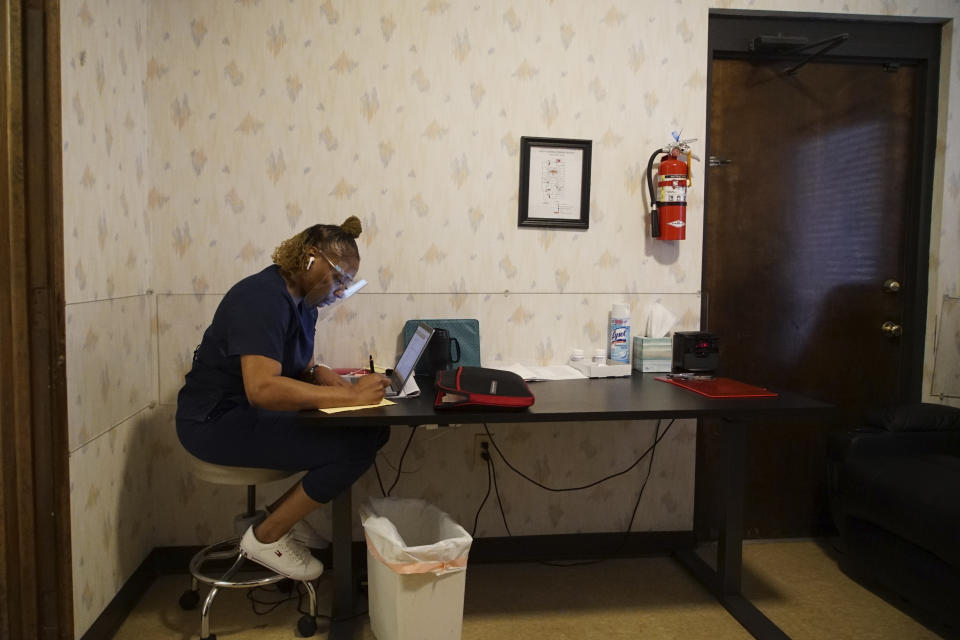 Ramona, who asked that her last name not be used, works in the recovery room at the West Alabama Women's Center in Tuscaloosa, Ala., on Tuesday, March 15, 2022. The green case against the wall contains her Bible, which she reads every day during her lunch break. (AP Photo/Allen G. Breed)