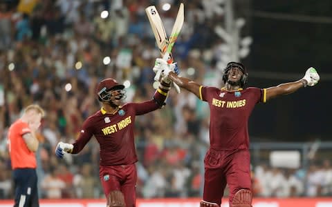 West Indies Carlos Brathwaite, right, celebrates with teammate Marlon Samuels - Credit: AP Photo/Saurabh Das