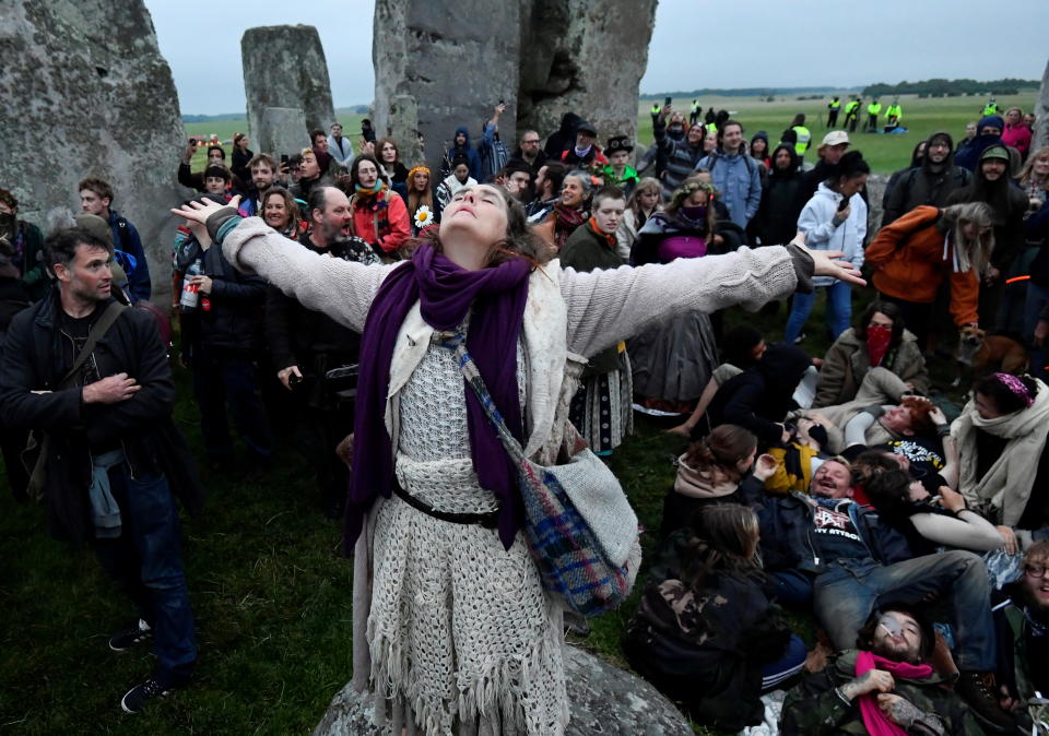 Revellers gather to celebrate the Summer Solstice at Stonehenge ancient stone circle, despite official events being cancelled amid the spread of the coronavirus disease (COVID-19), near Amesbury, Britain, June 21, 2021. REUTERS/Toby Melville