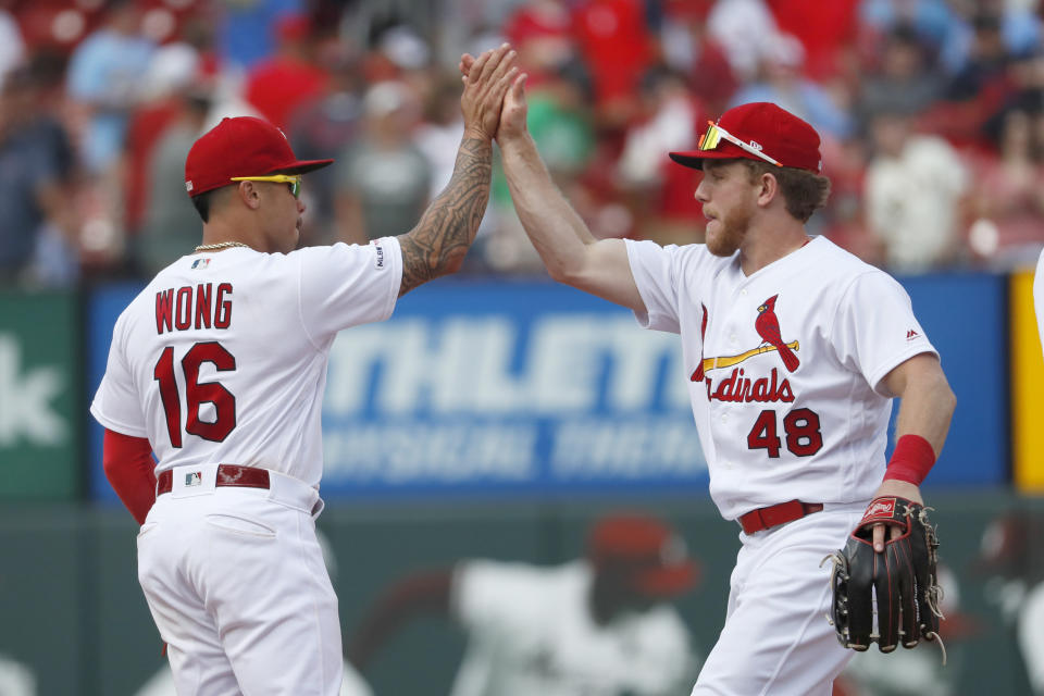 St. Louis Cardinals' Kolten Wong (16) and Harrison Bader (48) celebrate a victory over the San Francisco Giants in a baseball game Monday, Sept. 2, 2019, in St. Louis. (AP Photo/Jeff Roberson)