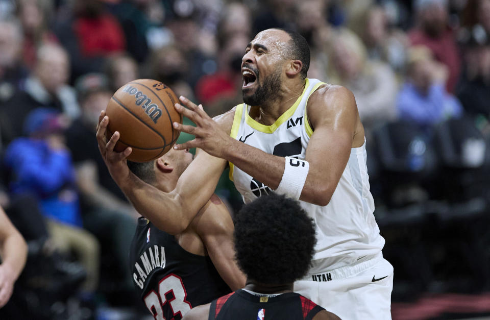 Utah Jazz guard Talen Horton-Tucker, right, shoots over Portland Trail Blazers forward Toumani Camara during the second half of an NBA basketball game in Portland, Ore., Thursday, Dec. 14, 2023. (AP Photo/Craig Mitchelldyer)