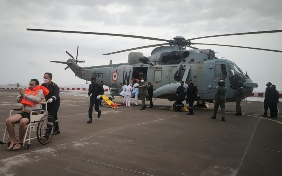 A man gestures after he was rescued by Indian Navy personnel from a sunken barge in the Arabian Sea in the aftermath of cyclone Tauktae's landfall - REUTERS